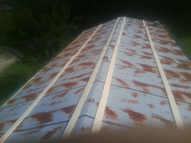 Rusted metal roof panels with new wood purlins before replacement — Storm Damage Roof Repair in Congerville by Roofing Brothers
